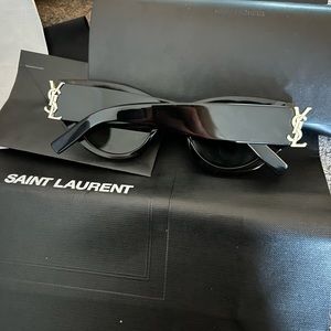 YSL black sunglasses, case, and shopping bag